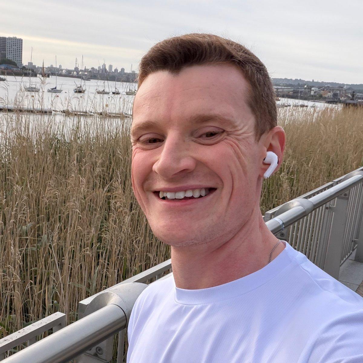 Jack Robinson, smiling, by the Thames in London